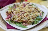 Appetizer of raw ham sticks, grapes, and hazelnut granules with balsamic vinegar